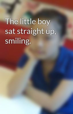 The little boy sat straight up, smiling.
